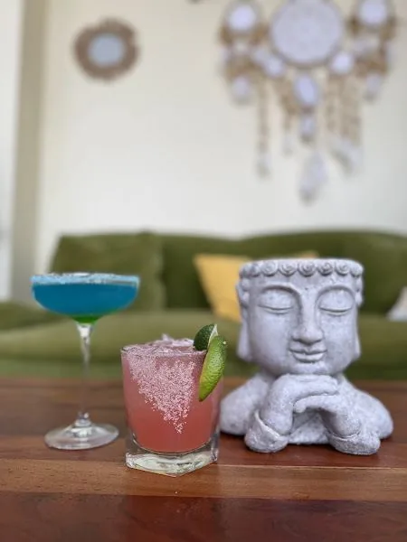 Buddha statue with cocktails and dreamcatcher