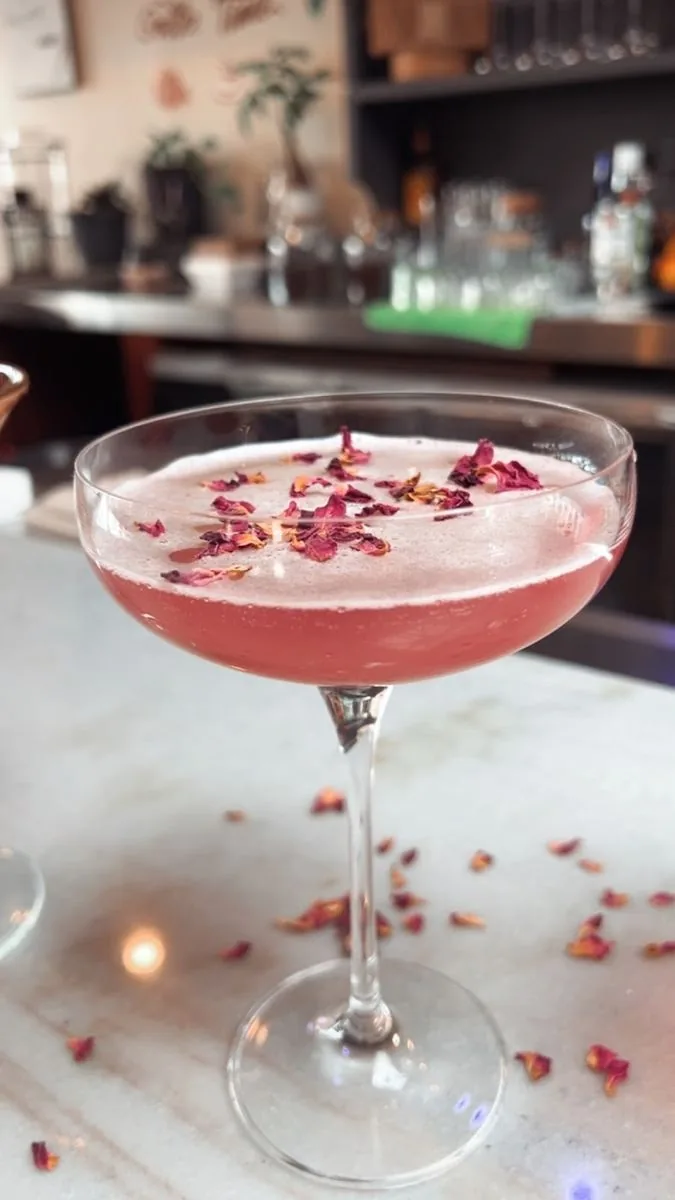 Rose petal craft cocktail in coupe glass