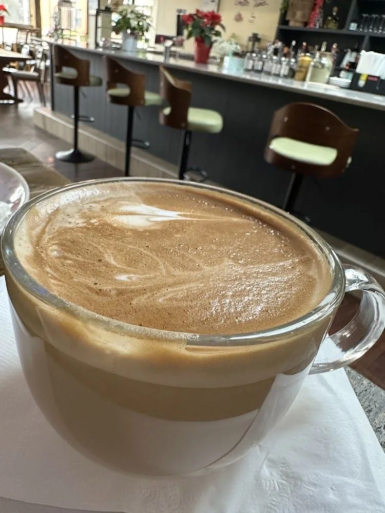 Latte in glass mug at the bar